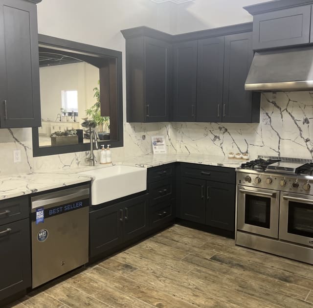 Everlasting kitchen with dark cabinets and a white backsplash