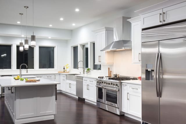 J&K S8 White shaker kitchen with a large island and stainless appliances