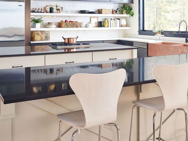 MSI Midnight Majesty black quartz on a kitchen island with light stools