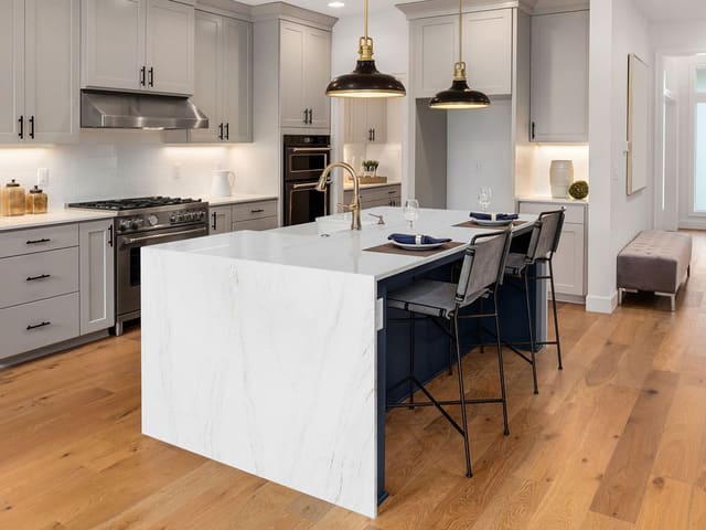 Spectrum Charming quartz in a white kitchen with a large island