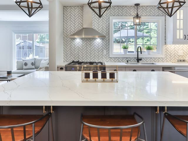 Spectrum Impeccable quartz island under glass pendant lights
