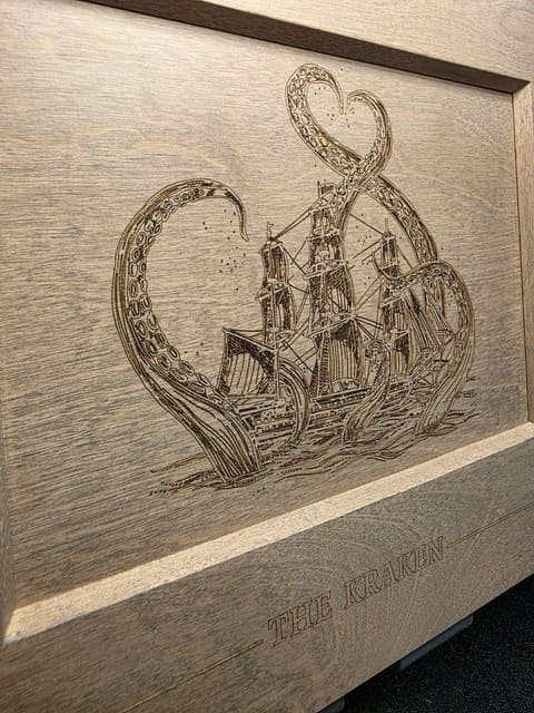Close-up of the kraken etching, showing the fine line detail in the tentacles and sails