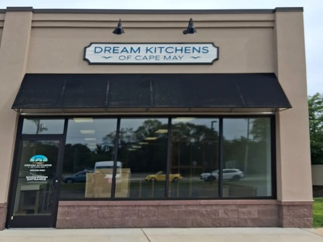 Dream Kitchens of Cape May storefront with its sign above a black awning and big showroom windows